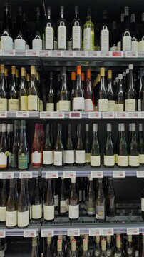 Shelves with Austrian and international wines bottles in a supermarket in Austria
