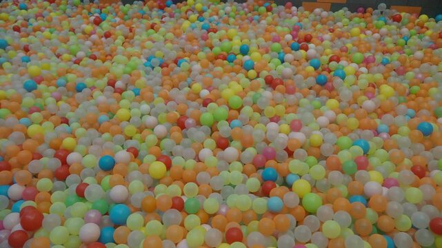 Colorful plastic balls in large ball pit for children playground indoor soft play center.