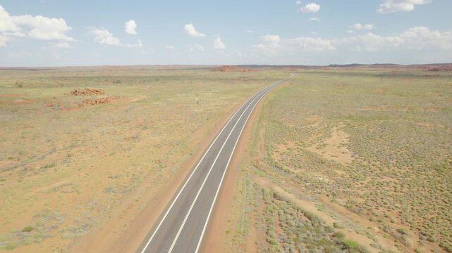 Empty Sealed Highway Stretching Through Remote Australian Outback