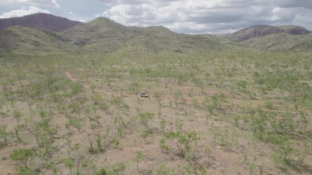 4WD Vehicle Travel Along A Red Track Through The Australian Outback