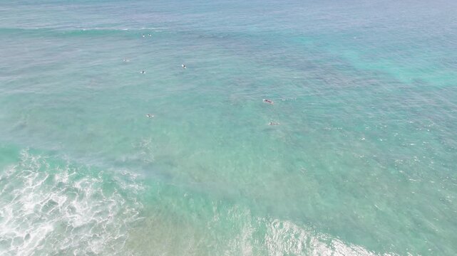 Red Bluff Surfers Riding Turquoise Ocean Waves Over Coral Reef