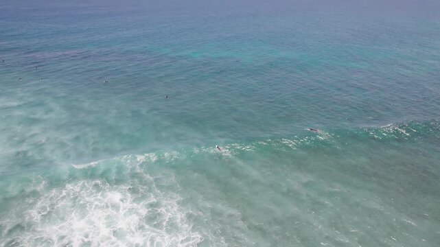 Surfers in Deep Blue Water Beyond Breaking Waves at Red Bluff