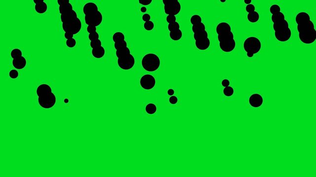 Black dots falling on a vibrant green background creating a dynamic motion visual effect