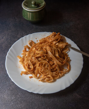 View from top of Italian food cooked fettuccine alfredo pasta in a white plate. Selective focus.