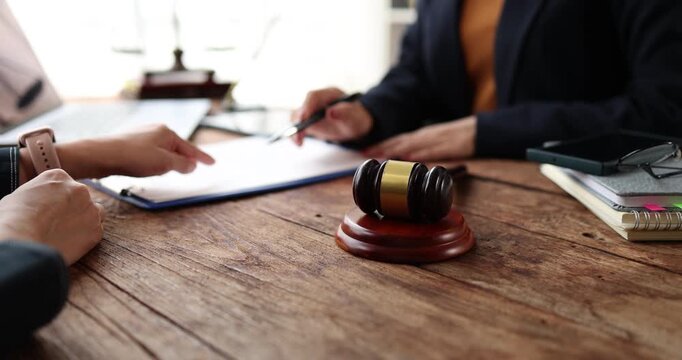 Legal professional consulting client in a modern office, offering expert advice and legal services, discussing important documents while providing professional support and justice