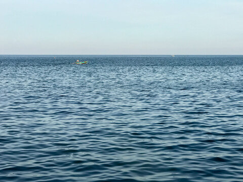 Blue ocean and little boat with clear sky