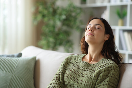 Teen in green breathing fresh air at home