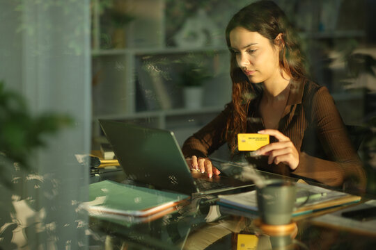 Young telecommuter working and paying online at home