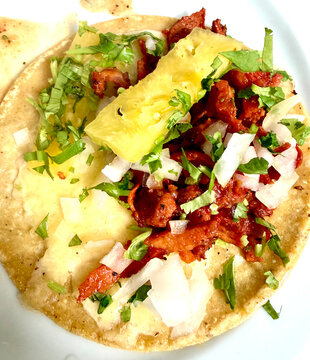 Delicious mexican taco al pastor with meat pineapple cilantro onion mexican food street food