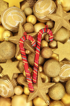 Christmas candy cane, gold sparkling star and ball bauble decorations. Festive fun Xmas background with decorative holiday symbols. Greeting card.