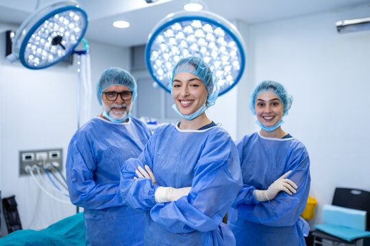 Successful surgeons smiling in operating room. Team of doctors wearing scrubs and surgical masks in hospital, Healthcare and medicine concept, Professional medical staff posing proudly after surgery.