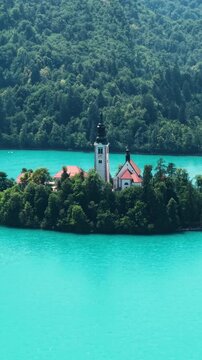 Lake Bled, Slovenia. Vertical Drone Shot Church of Blessed Virgin Mary on Small Island in Turquoise Water