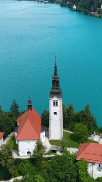 Vertical Drone Shot of Lake Bled and Catholic Church on Small Island, Blue Water and Landmark, Slovenia