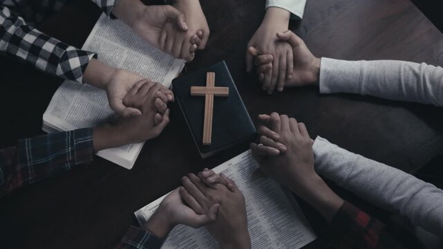 Young Christian Generation Praying in Unity Around Holy Bible