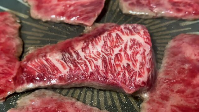 Fresh, well-marbled beef being seared in a frying pan_02