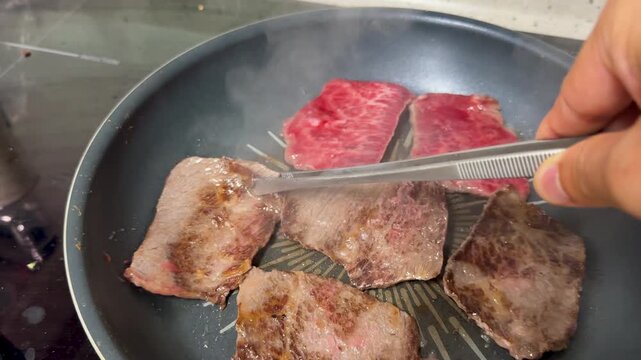 Fresh, well-marbled beef being seared in a frying pan_03