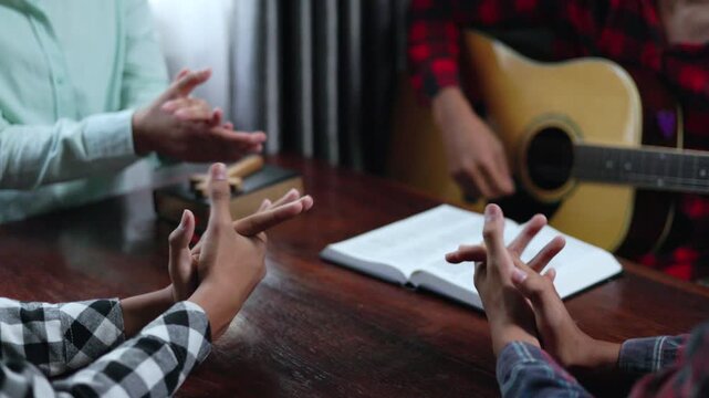 Group of Christian Teenagers Praying and Singing Spiritual Hymns in Fellowship