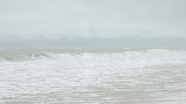 crazy seascape view of ocean sea under heavy storm strong wind weather with heavy huge wave to the sand beach. south sea of thailand in stormy weather