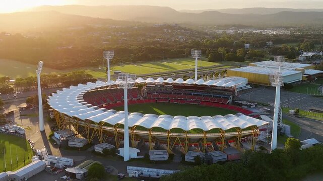 Aerial view of metricon stadium at sunset with gold coast hinterland landscape in queensland australia.