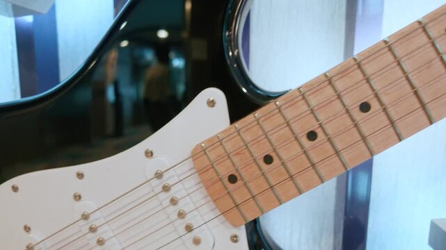 Close Up of Black Electric Guitar Body and Maple Fretboard