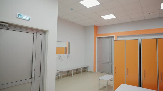 Orange lockers provide students with personal storage spaces. Children safely keep clothes backpacks shoes and books in changing room