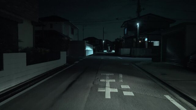 Creepy POV night walk in a dark residential area of Japan with cinematic cyan tint, approaching a road marking (Japanese text on the road translates to "Stop")
