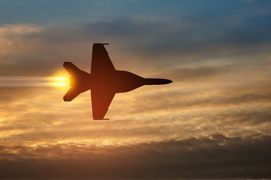 Air Force Day. Aircraft silhouette on background of sunset. Combat flight of interceptor on a mission.
