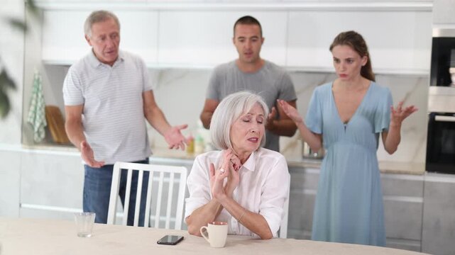 Portrait of thoughtful elderly woman who had conflict with his husband and adult children while cooking dinner in the kitchen . High quality 4k footage