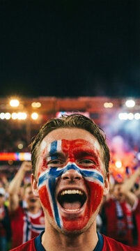 Young man shouting excitedly at stadium during match supporting national football team in bright festive atmosphere with painted face