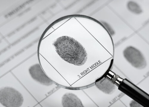 Magnifier and fingerprint police form.  Background on the theme of crime, police, fbi, detective, investigation, consequent; inquiry; inquest. 