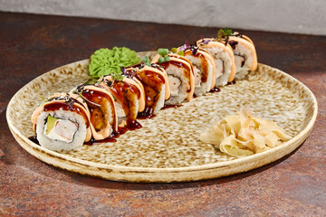 Tender eel topped maki with shrimp avocado and velvety spicy drizzle for a Japanese food blog recipe © Ryzhkov