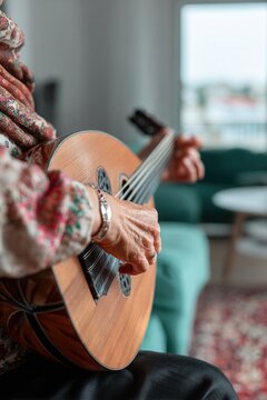 Senior woman's hands strumming an oud, creating traditional music in a living room