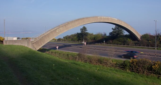 Wide zoom shot of the rainbow bridge over the A55. Taken from the south side of the road with cars and lorry&rsquo;s