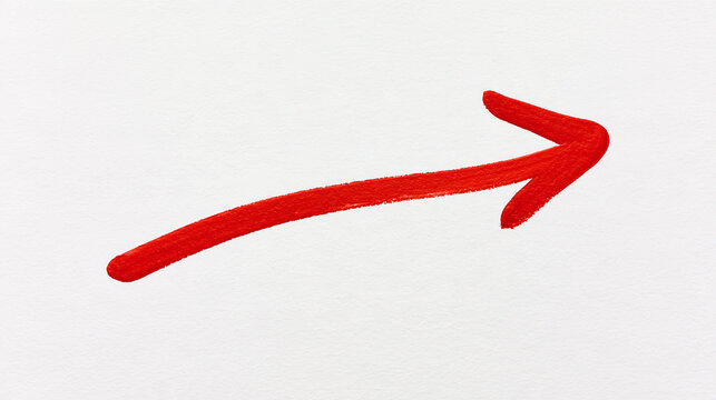 Red marker arrow pointing right hand side drawn on white paper texture