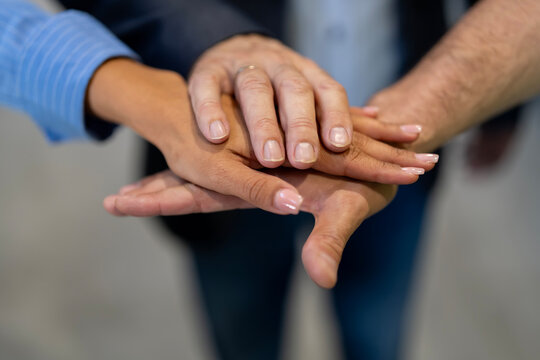 Business team hands stacking symbolizing unity support