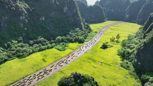 Tam Coc boat procession across rice valley during the Tam Coc festival in Ninh Binh, Vietnam
