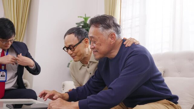 Asian senior gay couple meeting financial advisor or insurance agent at home, discussing retirement plan health insurance, financial security, future protection and sign agreement document together
