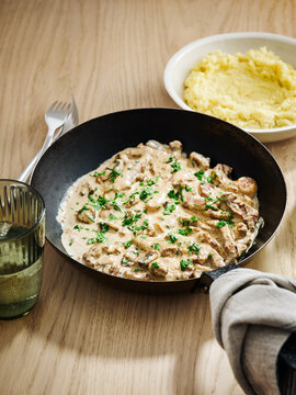 Creamy mushroom sauce with chicken, served with mashed potatoes, comfort food concept for family dining