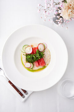 Watermelon salad with radishes and herbs, fine dining restaurant, summer refreshment idea