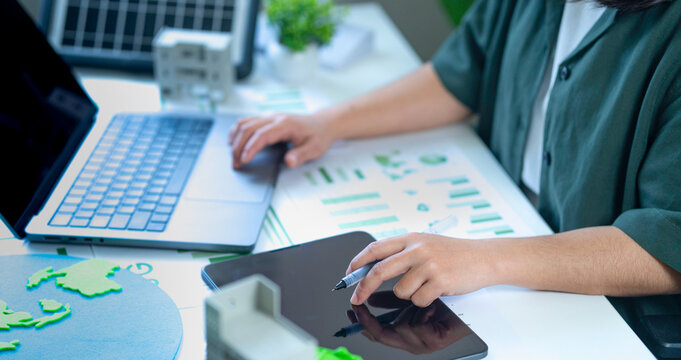 Analyzing renewable energy and ESG data while utilizing computers and tablets to prepare environmental impact reports, and leveraging technology to drive the organization toward sustainability and env