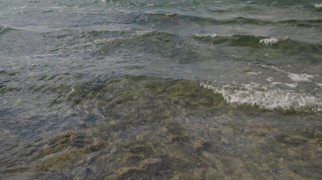 Slow motion handheld footage of lake Sevan in Armenia windy autumn season