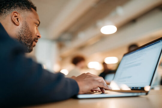 Confident Mature Man with Glasses and Beard Sitting in Bright Modern Office