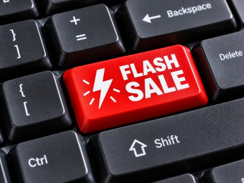Red flash sale button on black keyboard for e-commerce marketing and online discount promotion