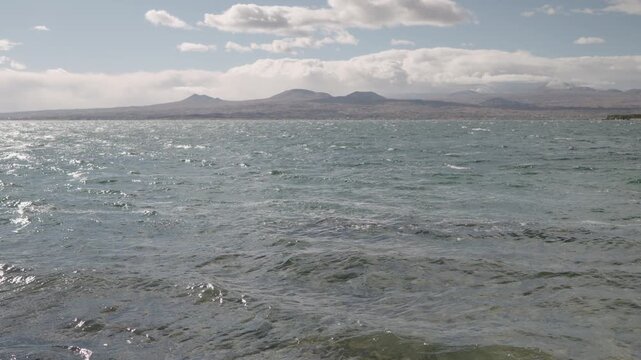 Slow motion handheld footage of lake Sevan in Armenia windy autumn season