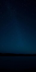Fototapeta premium Twinkling stars scattered across a pitch-black sky, with the gentle lapping of a lake's water in the background, serene, tranquility