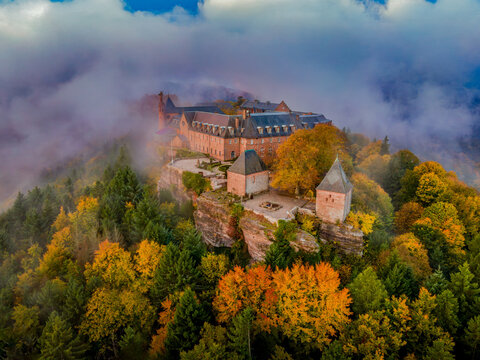 FRANCE, ALSACE, BAS-RHIN 67, AERIAL VIEW OF MONT SAINTE-ODILE ABBEY OVERLOOKING THE BRUCHE VALLEY, SURROUNDED BY GOLDEN AUTUMN VOSGES FORESTS AND MORNING MIST.