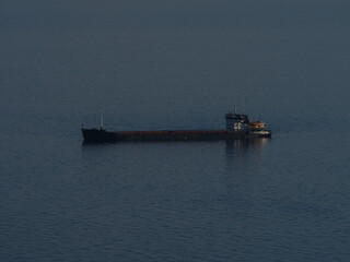 Fototapeta premium Heavy cargo ship anchored near the coast