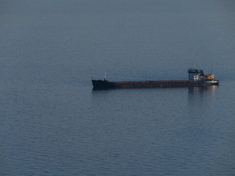 Heavy cargo ship anchored near the coast