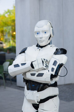 Futuristic android standing with arms crossed