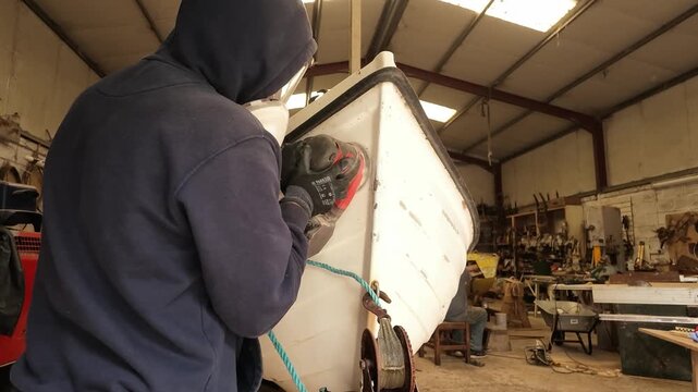 Sanding damaged fibreglass fishing boat gelcoat